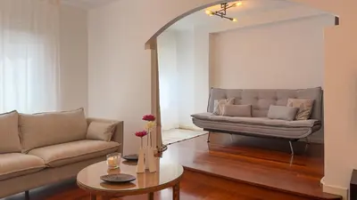 a living room with a couch and a table at VIVIENDA OLGA, piso tranquilo con parking a 10 min de Santiago in Sigüeiro