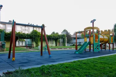 a playground in a park with a slide at VIVIENDA OLGA, piso tranquilo con parking a 10 min de Santiago in Sigüeiro