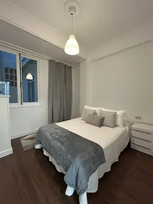 a white bedroom with a large bed in it at Apartamento en el casco historico in Ourense