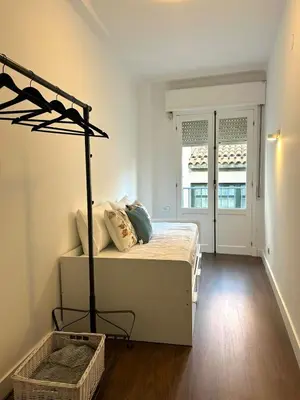 a bedroom with a bed in a room with a window at Apartamento en el casco historico in Ourense
