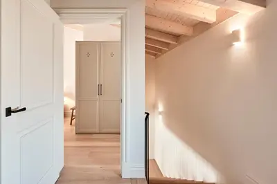 a hallway with white walls and wooden ceilings at Casa Conde in Furelos