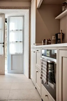 a kitchen with an oven and a door with at Casa Conde in Furelos