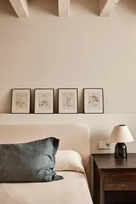 a bedroom with a bed with four pictures on the wall at Casa Conde in Furelos