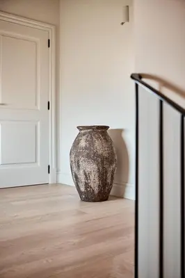 a vase sitting on the floor in a room at Casa Conde in Furelos