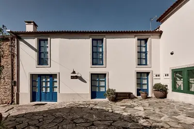 a large white house with blue doors at Casa Conde in Furelos