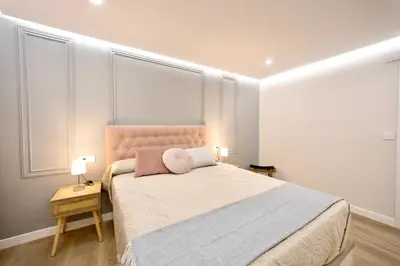 a bedroom with a large bed with two pillows on it at Train Station by Lugo Collection in Lugo