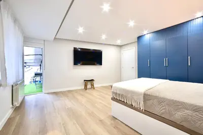 a bedroom with a bed and a tv on a wall at Train Station by Lugo Collection in Lugo