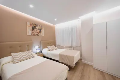 a hotel room with two beds and a window at Train Station by Lugo Collection in Lugo