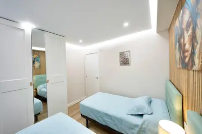 a small bedroom with a bed and a mirror at Train Station by Lugo Collection in Lugo