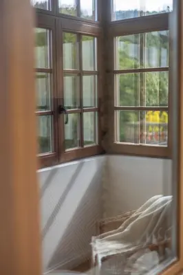 an empty room with two windows and a bed at Apartamentos Rurales Casa Carlota in Vegadeo