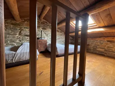 a bedroom in an attic with a bed in it at Casa El Reposo in Barreiros