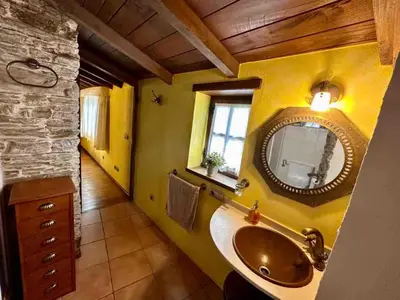 a bathroom with a sink and a mirror at Casa El Reposo in Barreiros