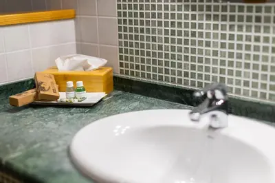 a bathroom with a white sink and a counter at Hotel O Cabazo in Ribadeo