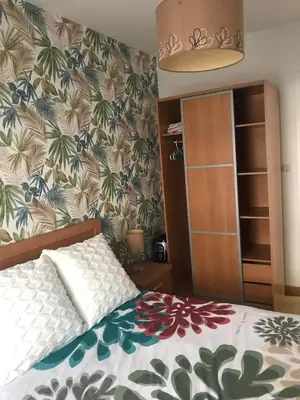 a bedroom with a bed with a floral bedspread at Apartamento cerca de la playa in Viveiro