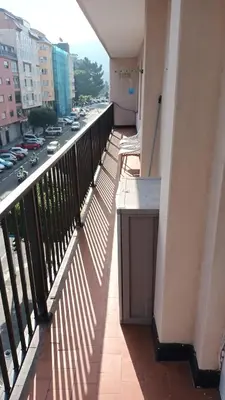 a balcony of a building with a view of a street at Apartamento cerca de la playa in Viveiro