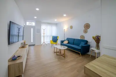 a living room with a blue couch and a table at Nataly,s House in Tapia de Casariego
