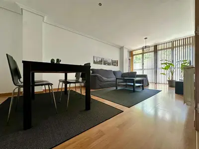 a living room with a table and a couch at A Gandarela in Ribadavia