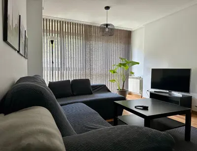 a living room with a couch and a tv at A Gandarela in Ribadavia