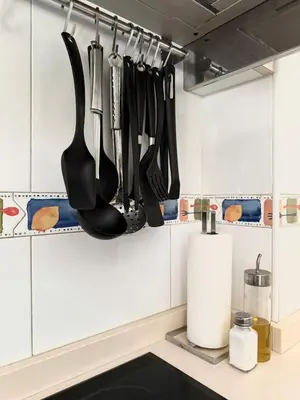 a kitchen with utensils hanging on the wall at A Gandarela in Ribadavia