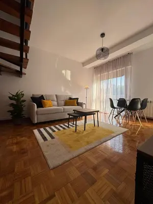 a living room with a couch and a table at Dúplex Carballiño in Carballino