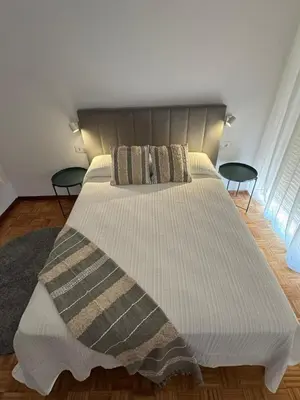 a white closet with hangers in a room at Dúplex Carballiño in Carballino