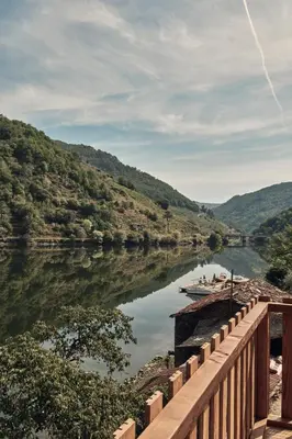 a bridge over a river with a boat on it at Pincelo Nature in Pincelo