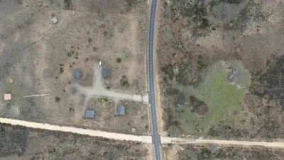 an aerial view of a field with a white pipe at Cabañas Vallecino in Manzanal de los Infantes