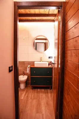 a bathroom with a sink and a toilet and a mirror at Casa Arxemil in Sarria