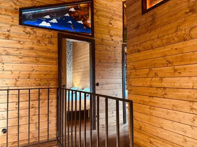 a staircase leading to a door in a wooden house at Casa Arxemil in Sarria