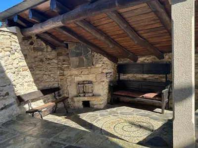 a stone room with a bed and a fireplace at Casa Arxemil in Sarria
