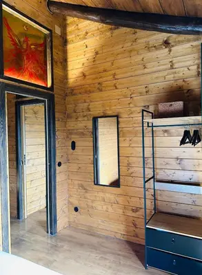 a room with a wooden wall with two windows at Casa Arxemil in Sarria