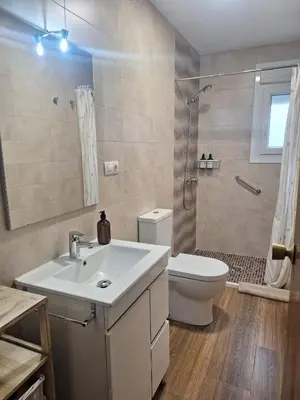 a bathroom with a sink and a toilet and a shower at Casa María in Baltar