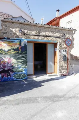 a building with a painting on the side of it at Oira House Jacuzzi Casa en Ourense in Ourense
