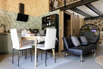 a dining room with a table and two chairs at Oira House Jacuzzi Casa en Ourense in Ourense