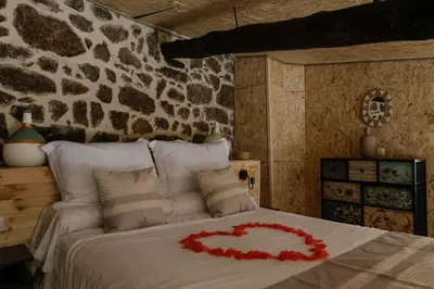 a bedroom with a bed with a heart on it at Oira House Jacuzzi Casa en Ourense in Ourense