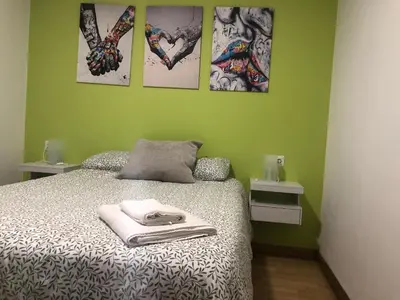 a bedroom with a bed and four pictures on the wall at Golfiños in Carballino