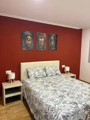a bedroom with a bed with three heads on the wall at Golfiños in Carballino