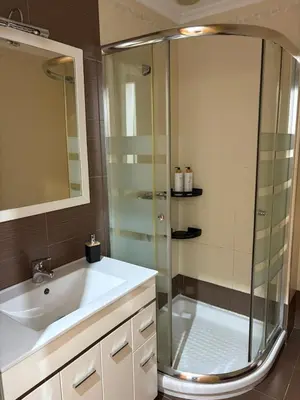 a bathroom with a glass shower and a sink at Golfiños in Carballino