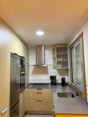 a kitchen with a stainless steel refrigerator and a sink at Golfiños in Carballino