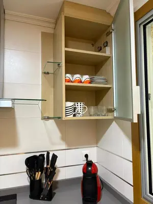 a cupboard with plates and utensils in a kitchen at Golfiños in Carballino