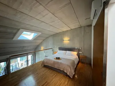 a bedroom with a large bed with a skylight at Loft Experience in Amés