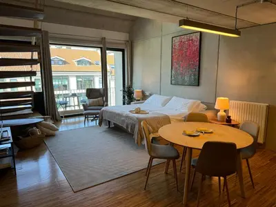 a bedroom with a bed and a table and chairs at Loft Experience in Amés
