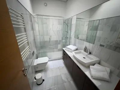 a white bathroom with a sink and a mirror at Loft Experience in Amés