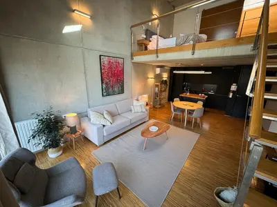 a living room with a couch and a loft at Loft Experience in Amés