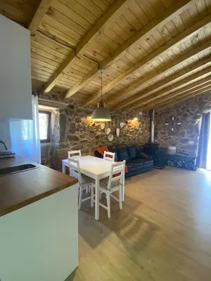 a kitchen and dining room with a table and chairs at Casa de Piedra Vistas & Relax