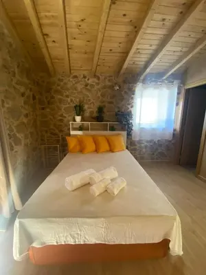 a bedroom with a large bed with towels on it at Casa de Piedra Vistas & Relax