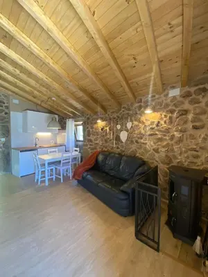 a living room with a couch and a table at Casa de Piedra Vistas & Relax