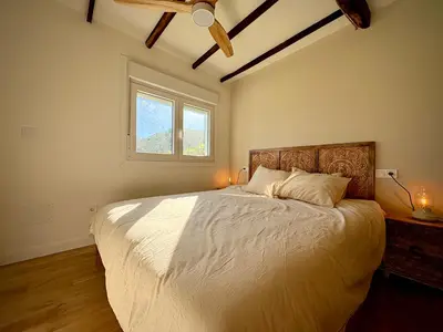 a bedroom with a large bed and a window at Wine Lodge Ribeira Sacra in Carracedo