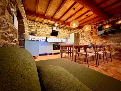 a kitchen and dining room with a table and chairs at Wine Lodge Ribeira Sacra in Carracedo