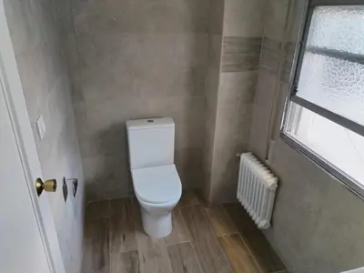 a bathroom with a toilet and a window at Apartamento en Carballiño in Carballino